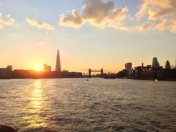 View of city at waterfront during sunset