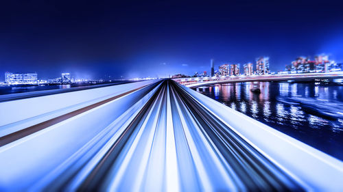 Illuminated bridge against sky at night