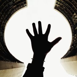 Low angle view of hand against clear sky