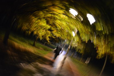 Blurred motion of illuminated tunnel at night