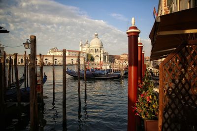 View of boats moored in city at waterfront