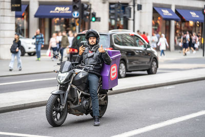 Man riding motorcycle on city street