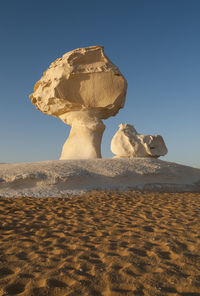 Low angle view of rocks against blue sky