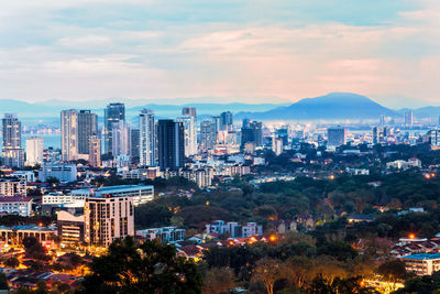 High angle view of illuminated buildings in city against sky