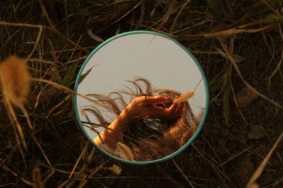 Reflection of woman on grass