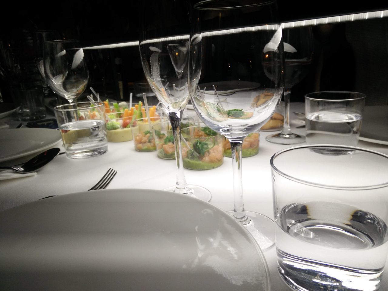 CLOSE-UP OF WINE GLASSES ON TABLE IN KITCHEN