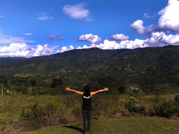 Full length rear view of man standing on mountain