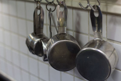 Close-up of utensils hanging in kitchen