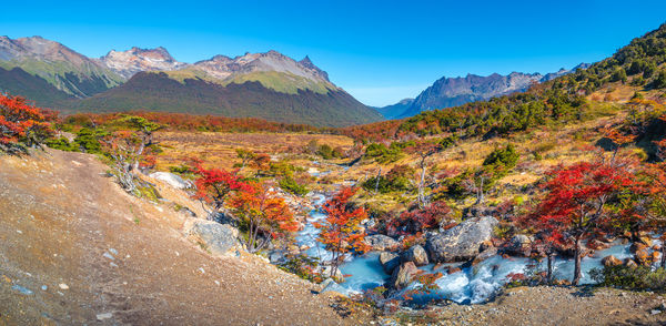 Scenic view of mountains against clear blue sky