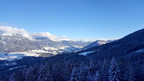 Scenic view of mountains against blue sky