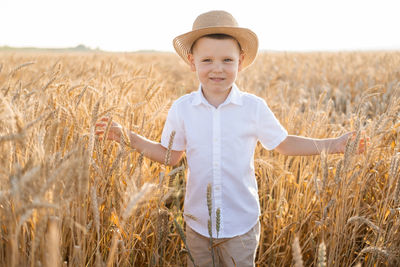 Portrait of boy standing on field