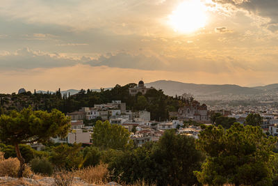 Townscape against sky during sunset