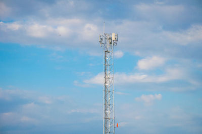 Low angle view of communications tower against sky