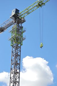 Low angle view of crane against sky