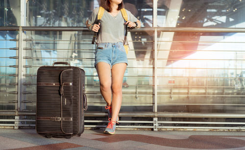 Full length of woman using mobile phone