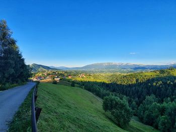 Scenic view of landscape against blue sky