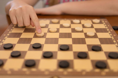 Cropped hand of woman playing jigsaw puzzle