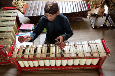 High angle view of man playing traditional music
