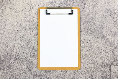 Close-up of white paper on wall