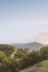 Scenic view of field and mountains against sky