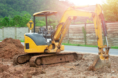 Horse cart on road by construction site