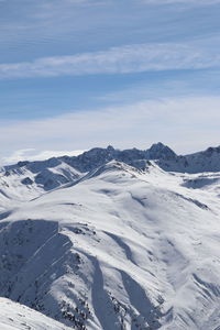 Scenic view of snowcapped mountains against sky