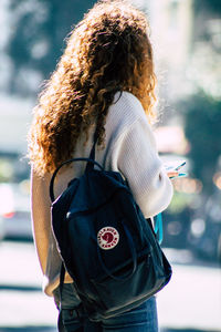 Rear view of woman standing outdoors