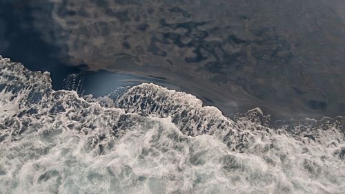 High angle view of rocks in sea