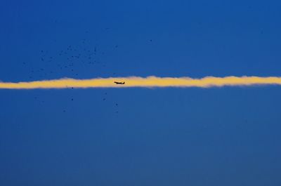 Airplane flying over clear blue sky