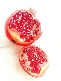 Close-up of red fruit over white background