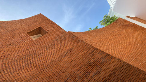 Low angle view of building against cloudy sky