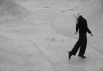 Woman in black  performing on the grey   concrete pool 