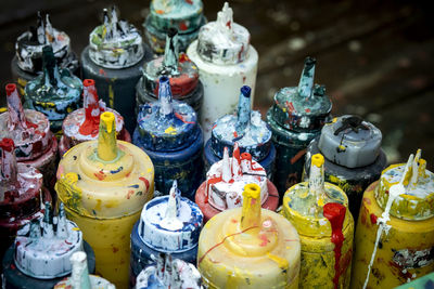 High angle view of paint bottles