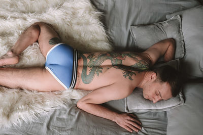 High angle view of woman sleeping on bed