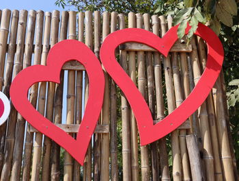 Low angle view of heart shape on wooden fence