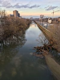 Scenic view of river against sky at sunset