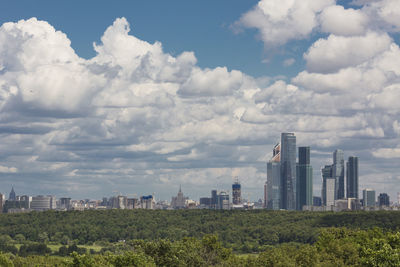 View of cityscape against cloudy sky