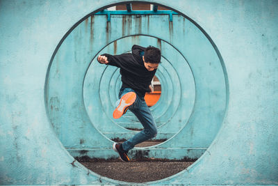 Man jumping through blue circles