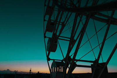 Low angle view of silhouette ferris wheel against sky