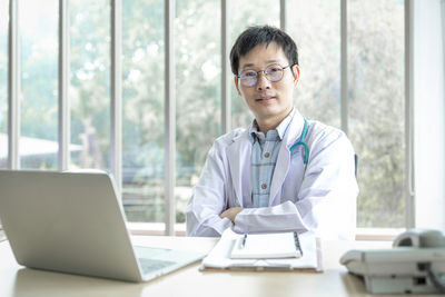 Portrait of businesswoman working at desk in office