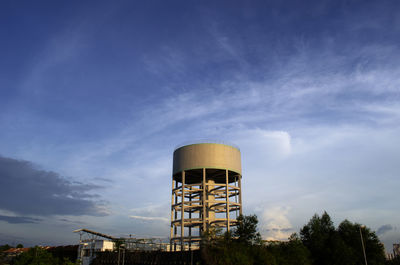 Low angle view of water tower against blue sky