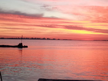 Scenic view of sea against orange sky