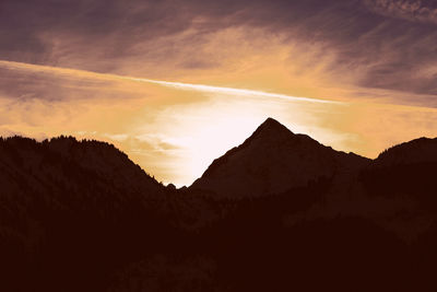 Silhouette mountains against dramatic sky