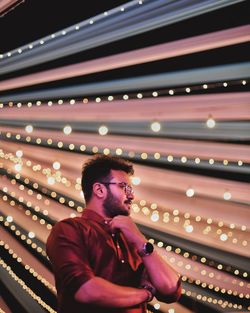 Full length of young man looking away at night