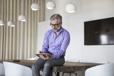Businessman in boardroom using tablet