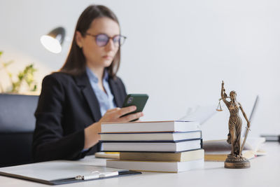 Portrait of woman using mobile phone on table