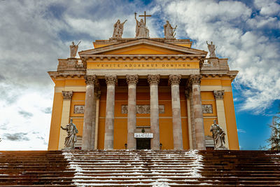 Low angle view of historic building against cloudy sky