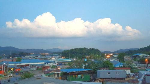 High angle view of town by sea against sky