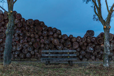 Stack of logs against clear sky