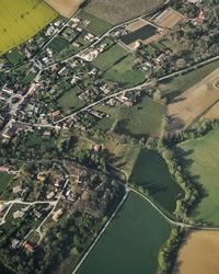 Aerial view of agricultural field by buildings